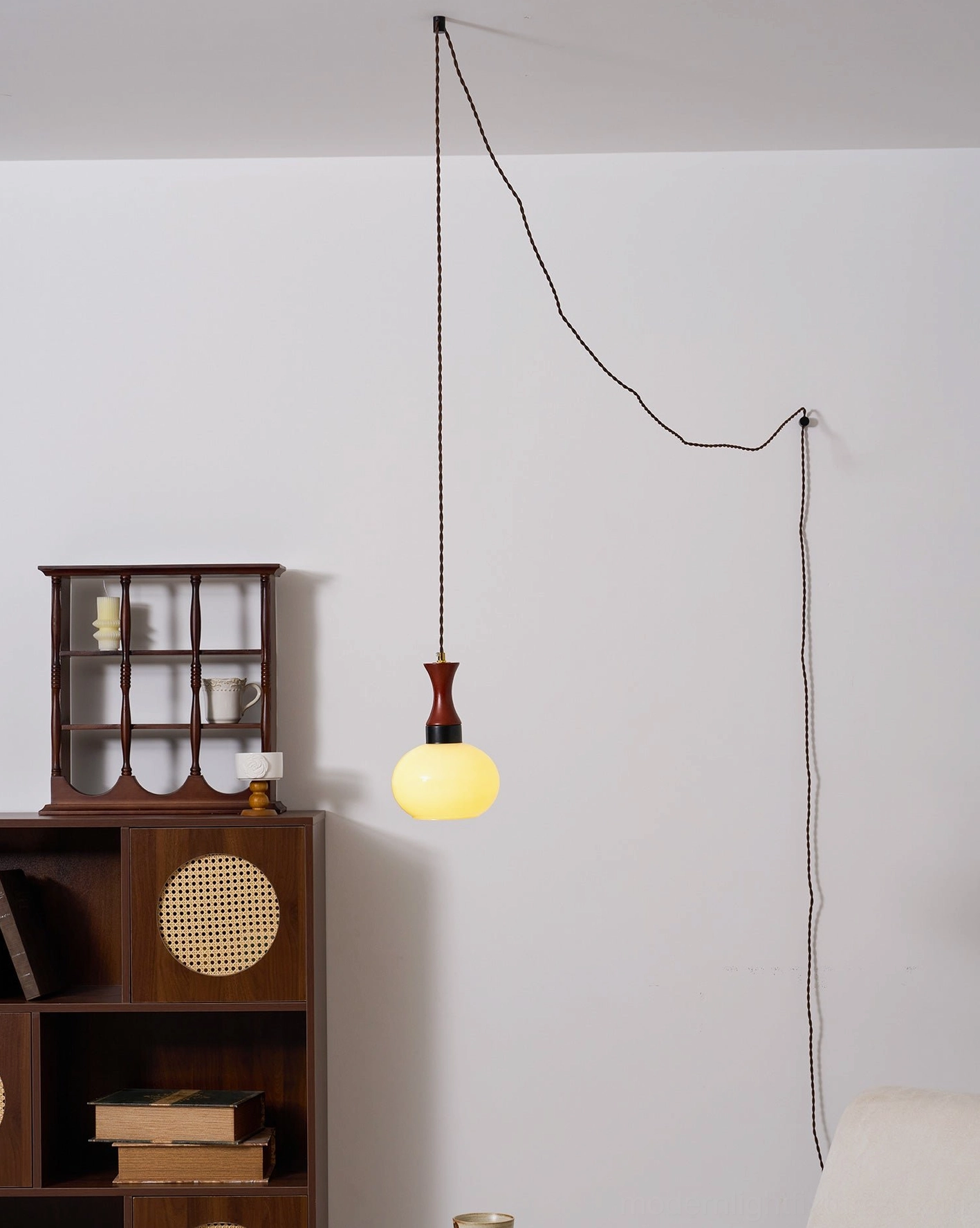 Modern pendant lamp installed in eclectic interior with mixed furnishings and decor
