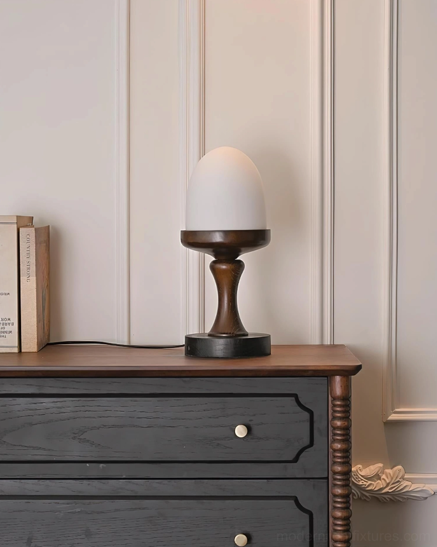 Unlit egg-shaped table lamp showing matte white frosted glass shade and dark wood base detail, side profile