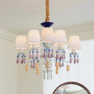 8-arm blue and white ceramic chandelier with decorative crystal pendants in minimalist white interior