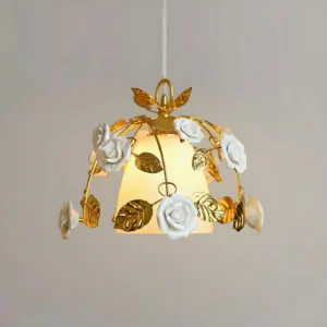 Lit Eirene pendant chandelier showing illuminated frosted glass dome with decorative gold leaf accents and white roses