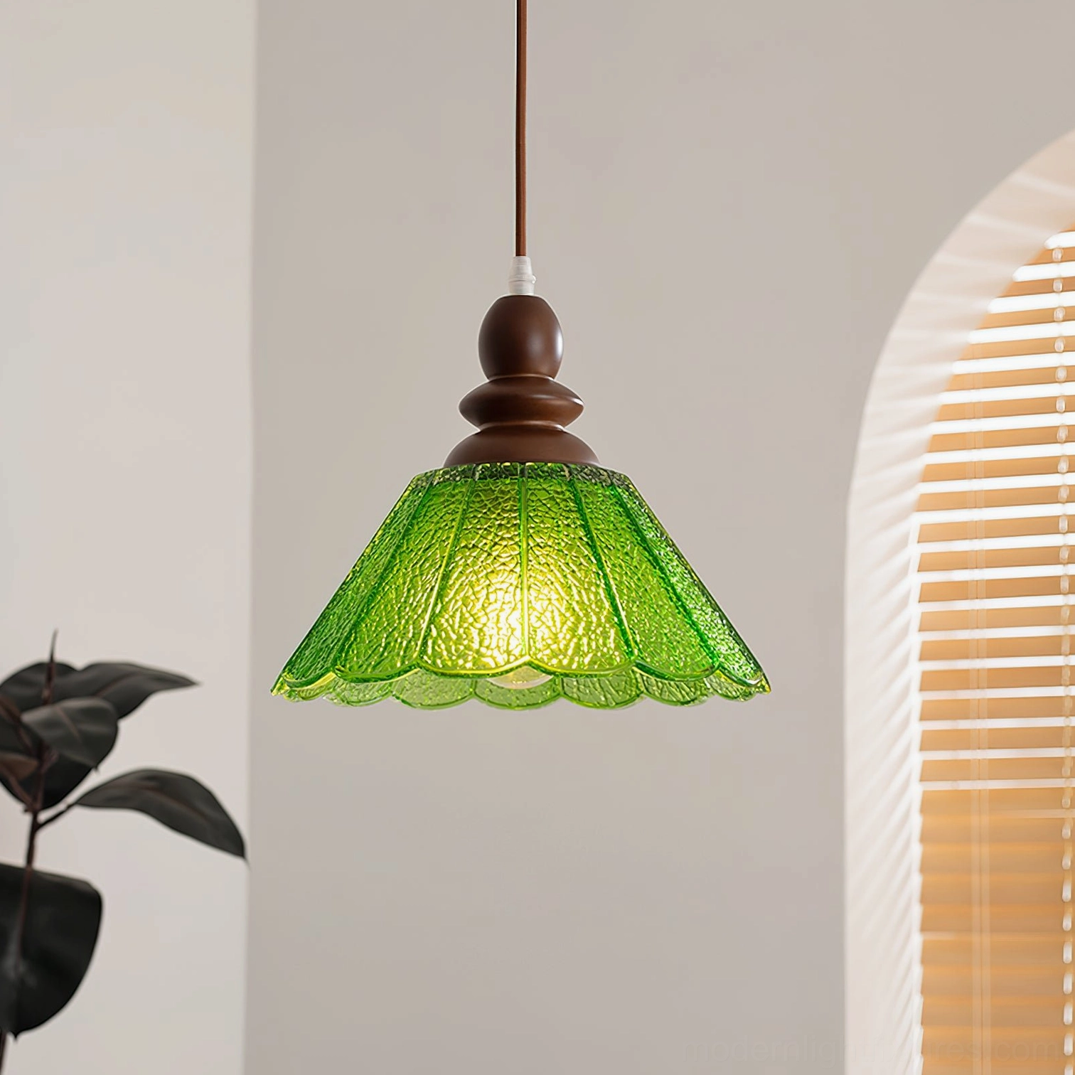 Elara green scalloped glass pendant light installed in residential interior with arched window, vintage home lighting