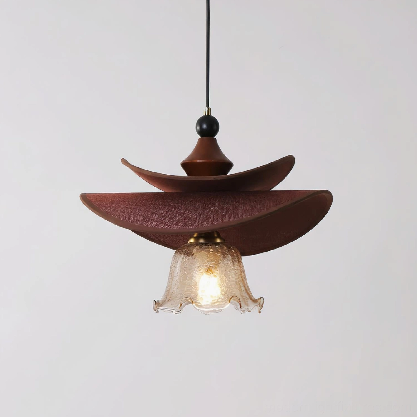Elaren pendant light with cognac brown wood finish, hanging in modern space, decorative focus