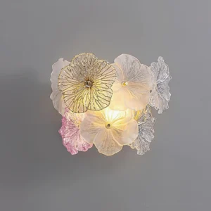 Elaria pink and clear glass wall lamp frontal perspective with warm glowing botanical design
