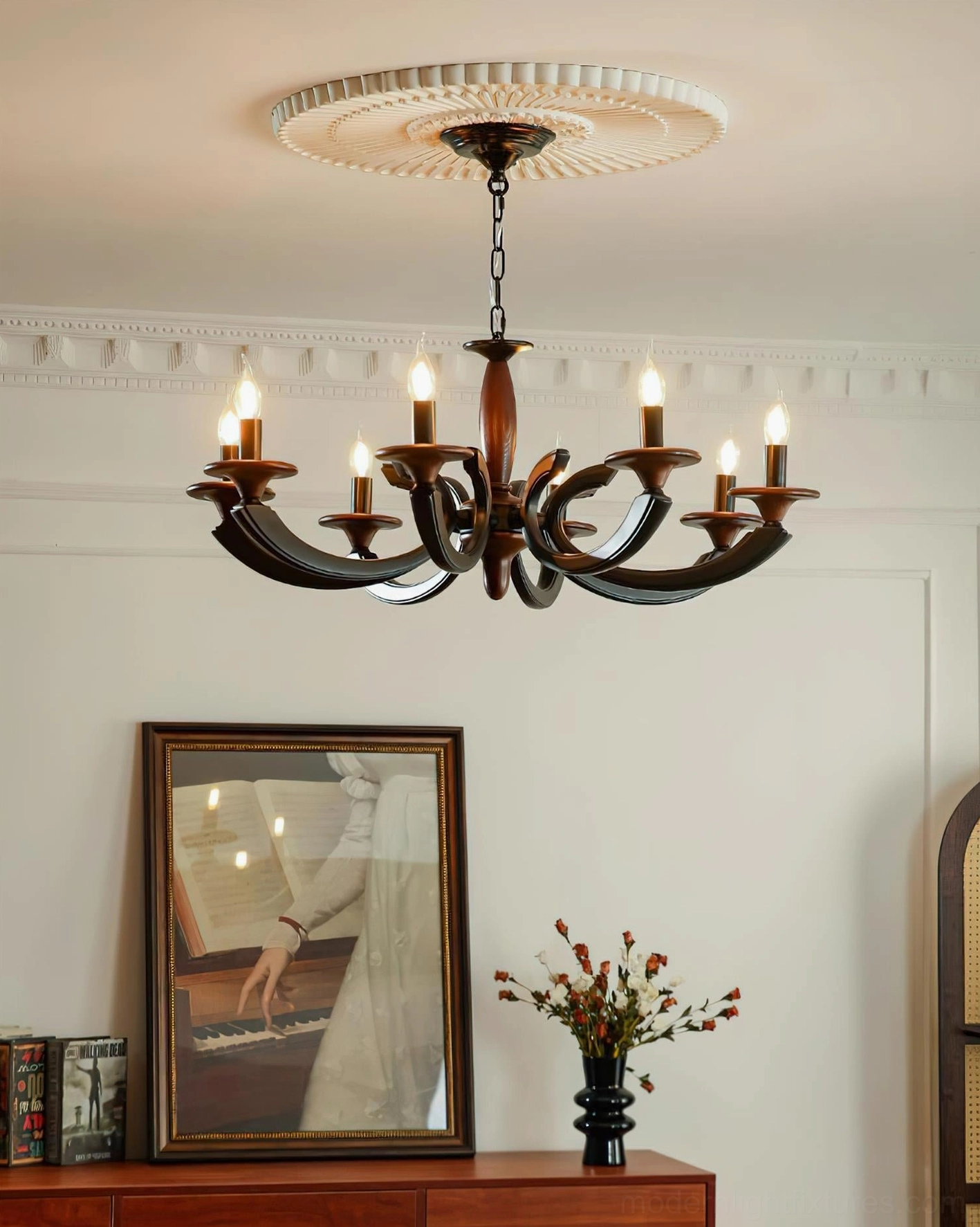 Eldric 8-arm chandelier in living room with black metal arms walnut wood frame and ceiling medallion accent