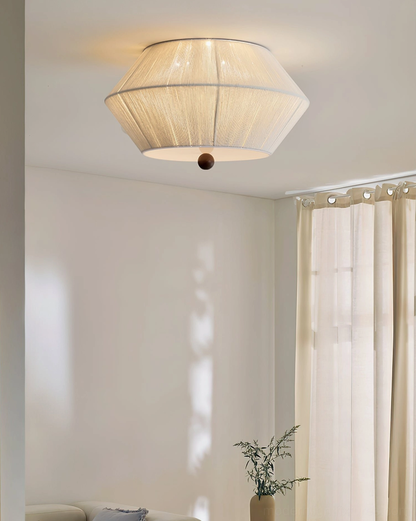 Warm-toned fabric drum shade ceiling light creating elegant ambient glow for contemporary spaces