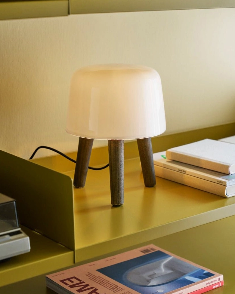 Elegant milk glass table lamp with soft diffused light, natural wood base available in multiple finish options