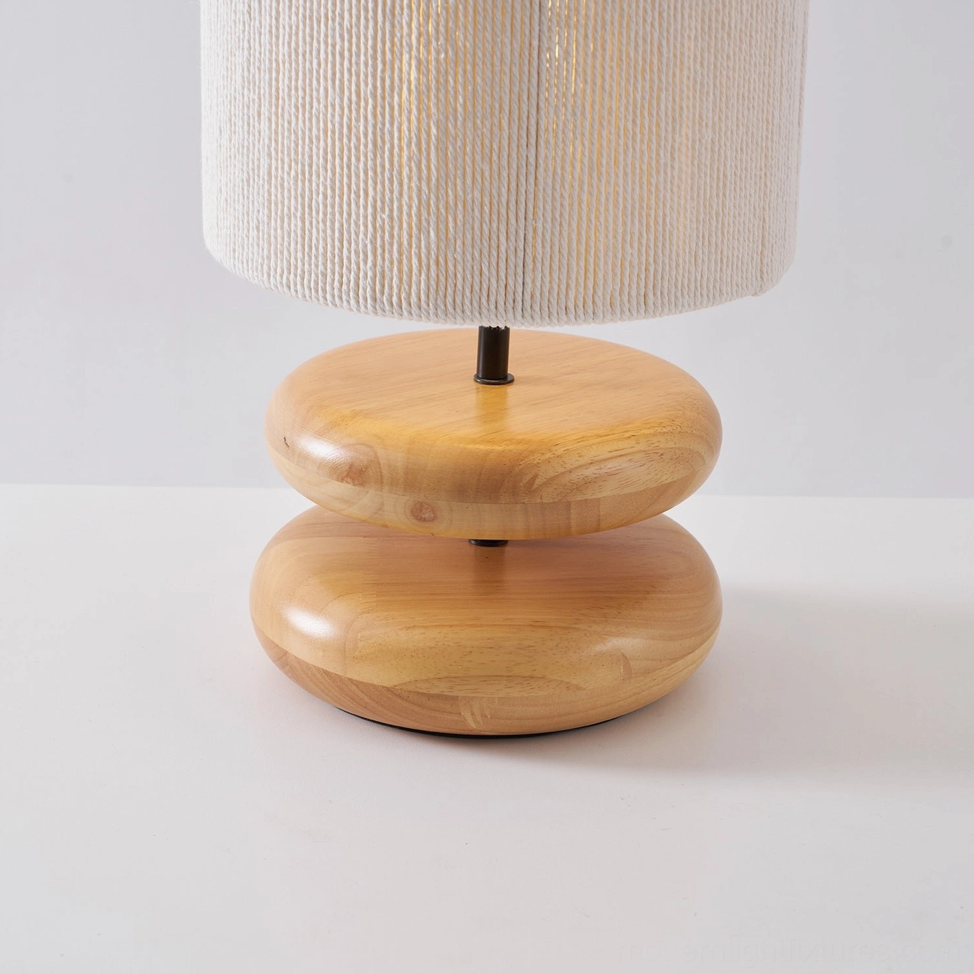 Elegant wooden lamp base with hand-turned details and warm fabric shade complement