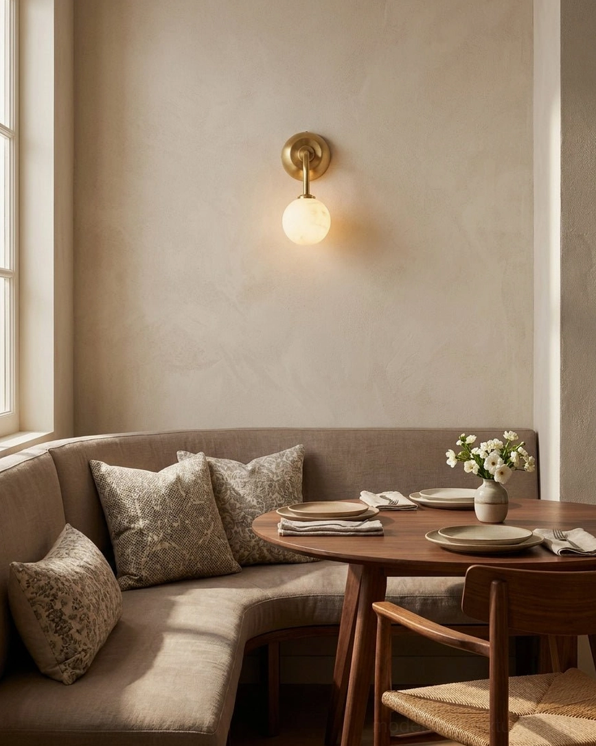 Dining nook built-in booth with Elio wall-mounted brass sconce providing warm ambient accent lighting