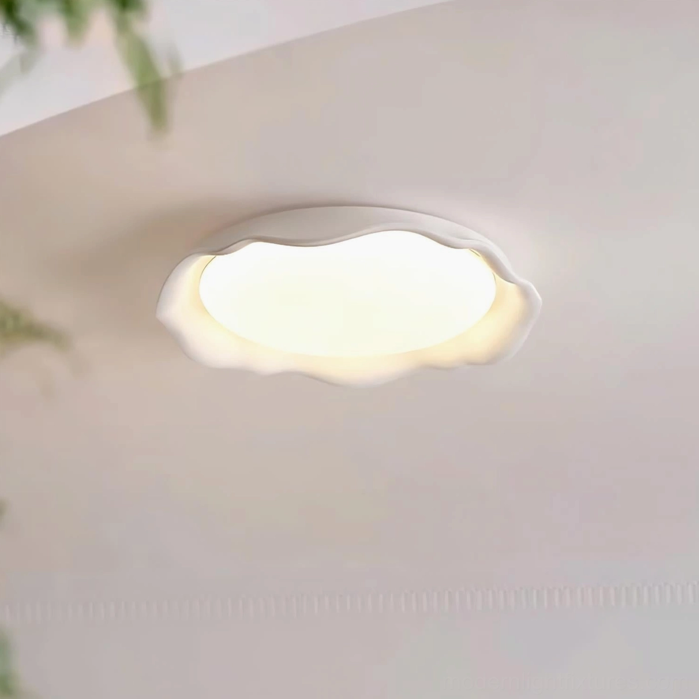 Elio scalloped ceiling lamp flush-mount fixture, white matte finish, wavy rim detail, warm light near green plant foliage