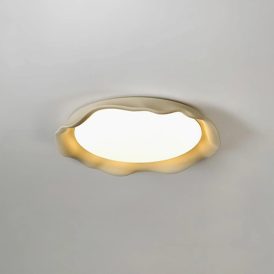 Elio LED ceiling light in cream yellow finish, beige outer trim, warm glowing diffuser, low-angle ceiling view