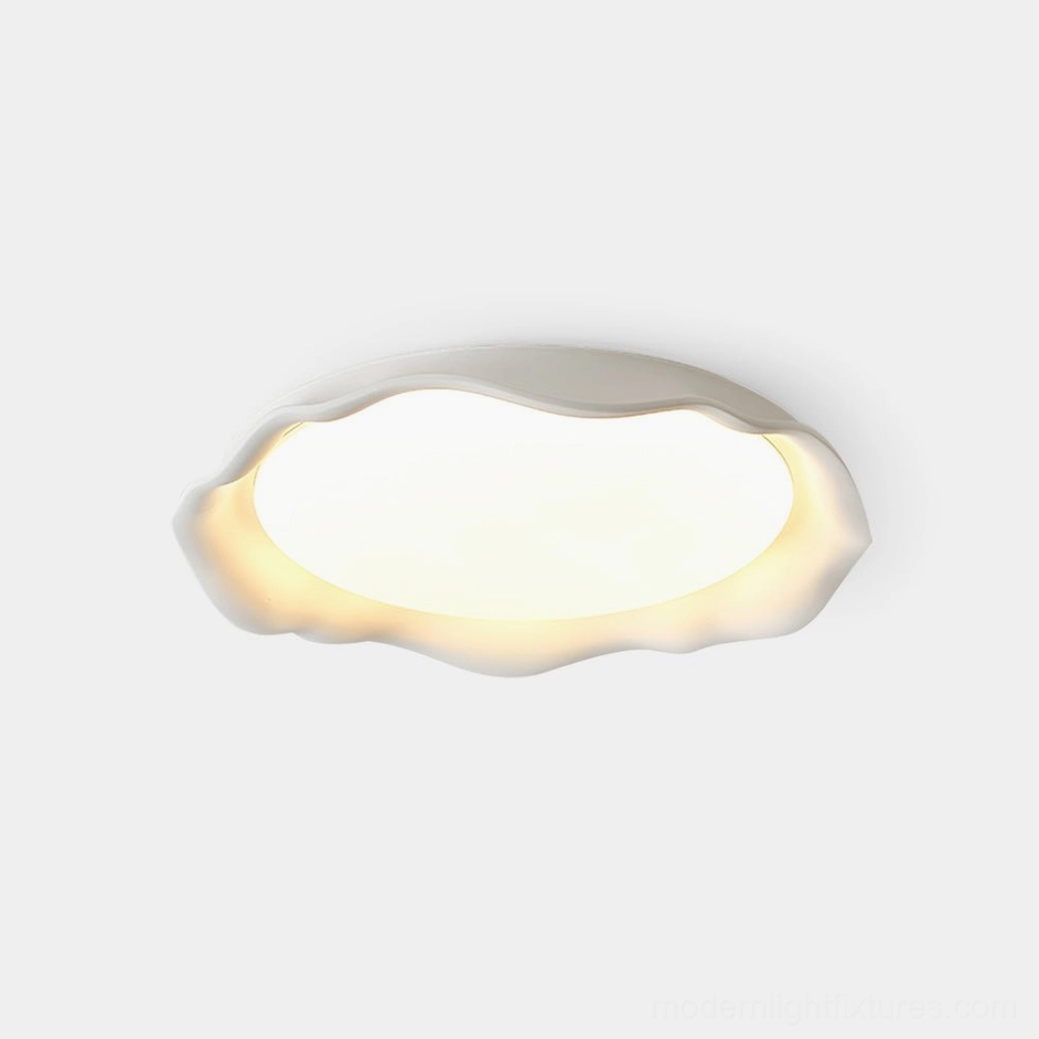 Elio scalloped concrete ceiling light with wavy edge, matte white finish, front flat view against plain white background