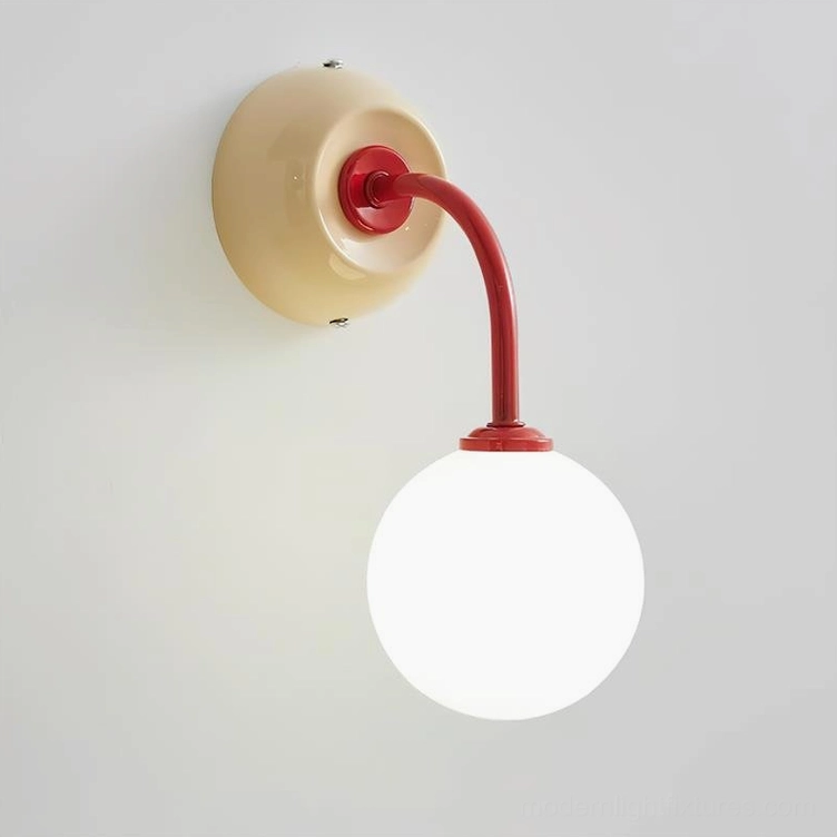 Elio wall sconce beige base with red curved arm variant in modern interior setting