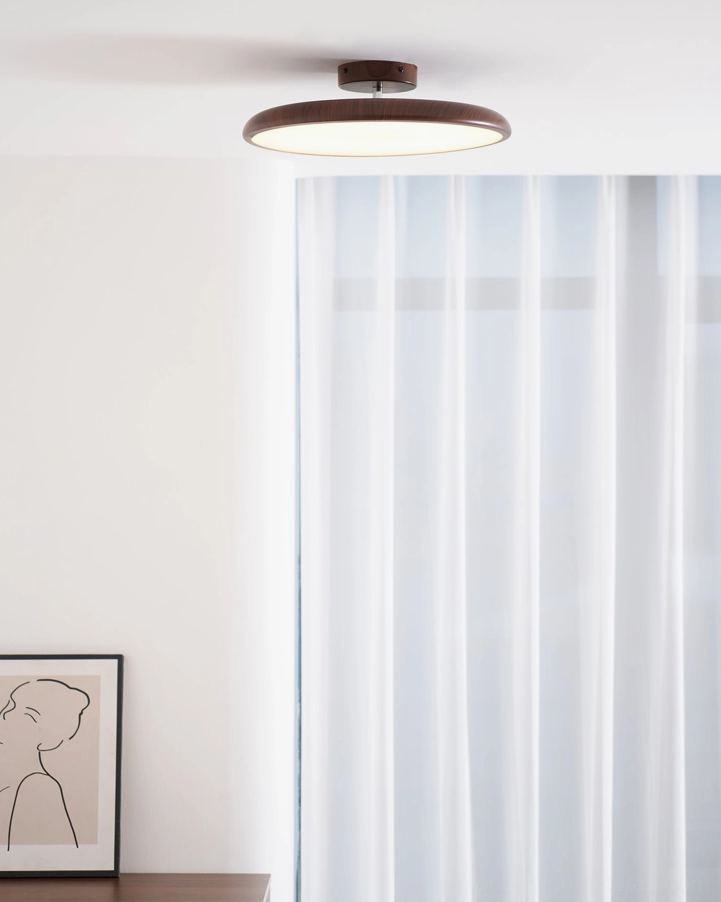 Ellos ceiling light in Scandinavian modern living room with sheer curtains and wall art