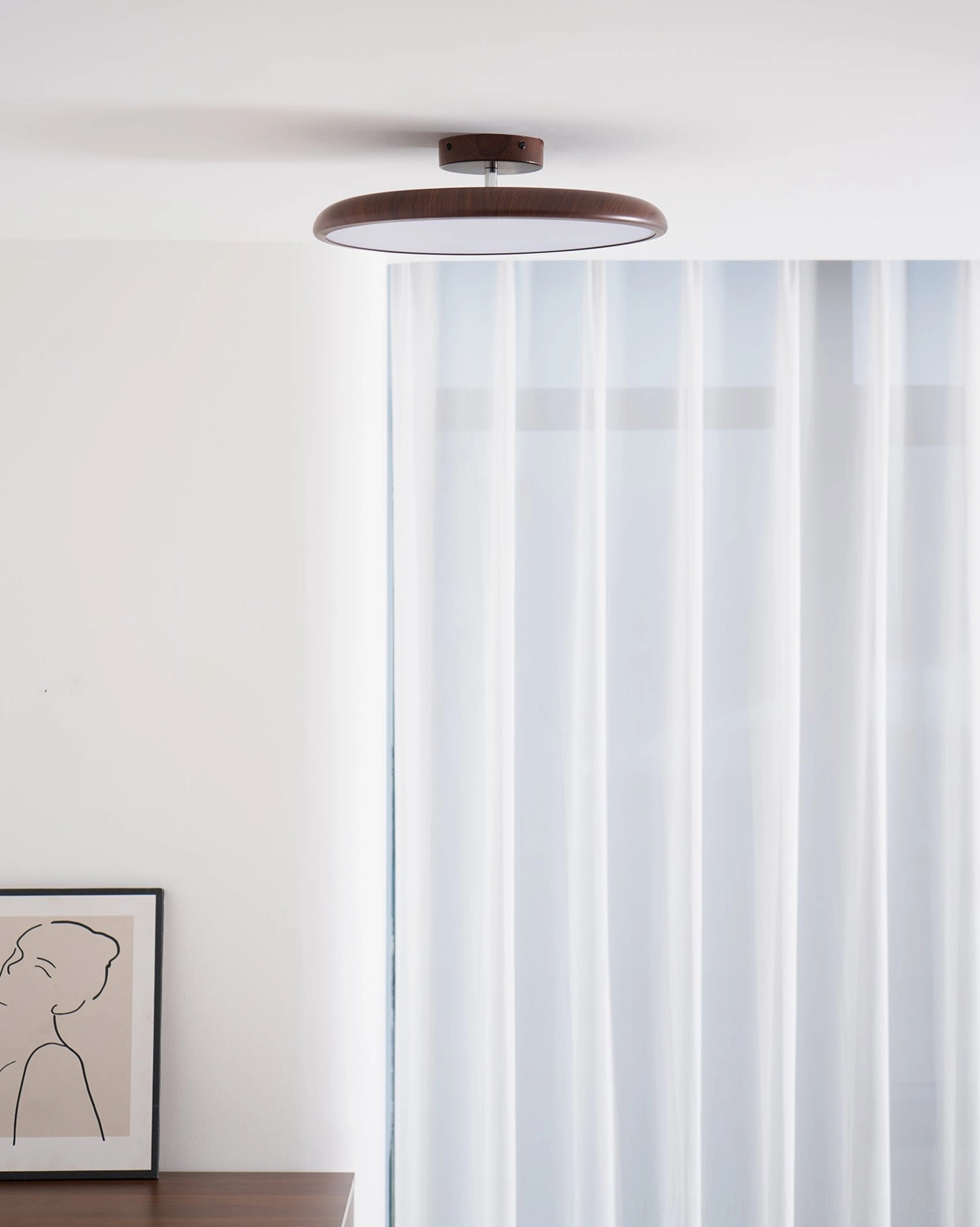 Ellos wood-grain ceiling light in Scandinavian living room with neutral wall decor