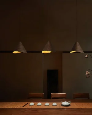 Three-head wooden cone pendant light cluster installed above dining table in warm contemporary tea room
