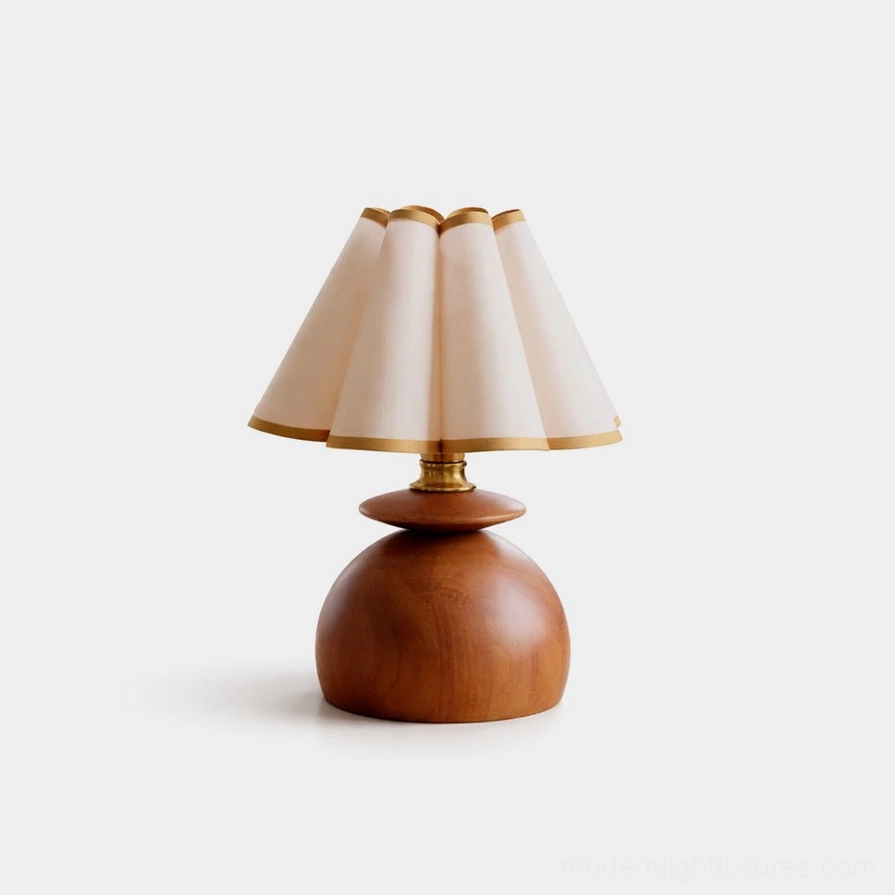 Elmora mid-century modern table lamp with walnut wooden base and pleated off-white fabric shade, gold-trimmed details, front studio view