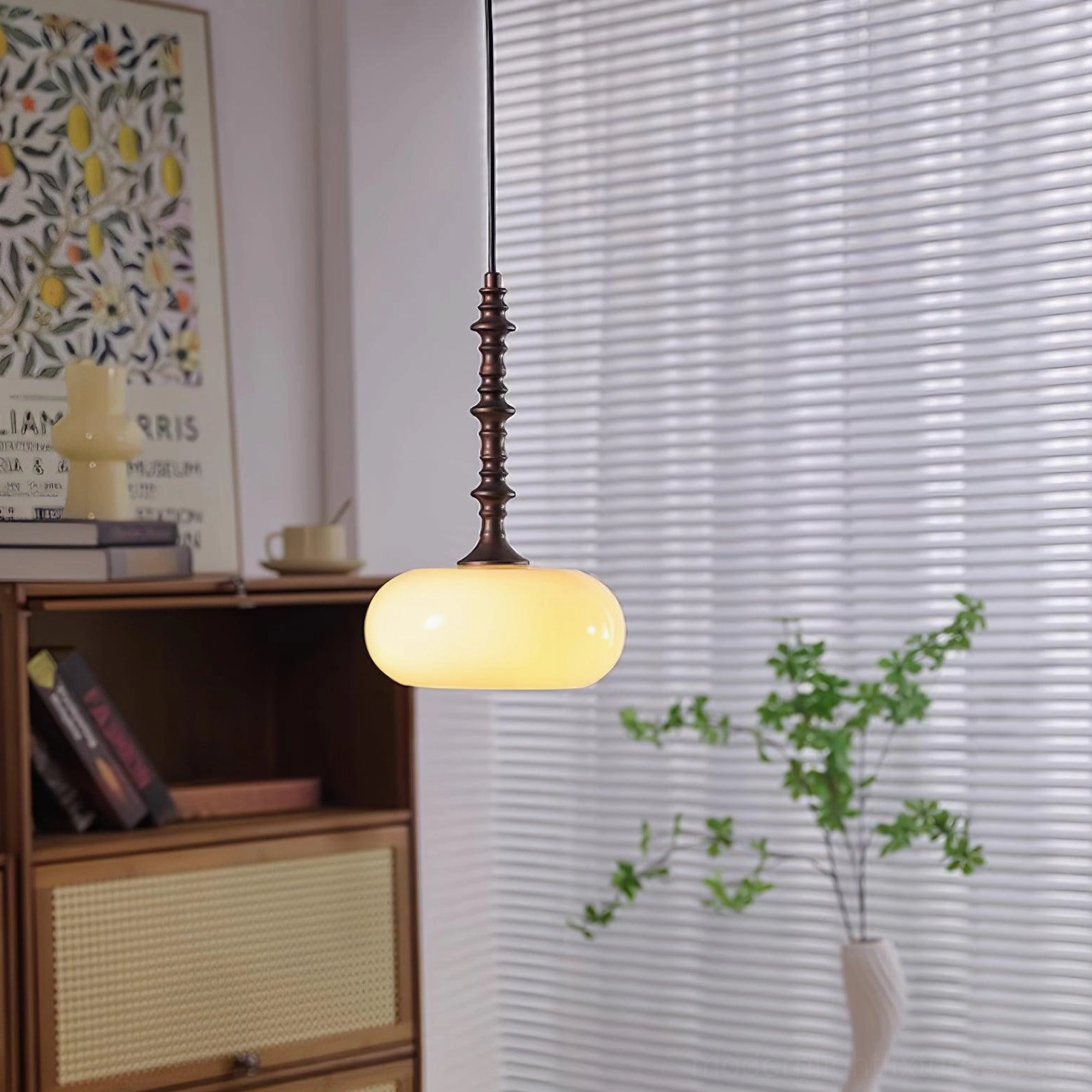 Artistic pendant lamp fixture with frosted glass shade and sculptural dark brown metal stem detail