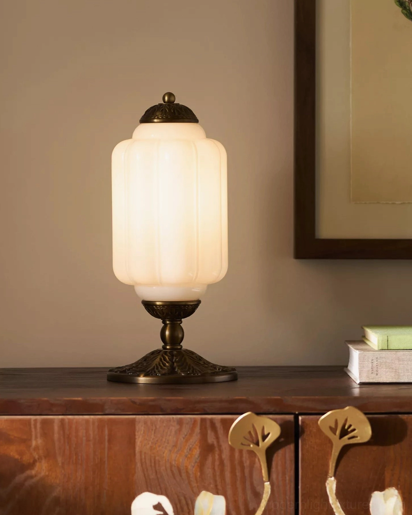Eloise table lamp in emerald green showing ornate brass detailing and sculptural glass design