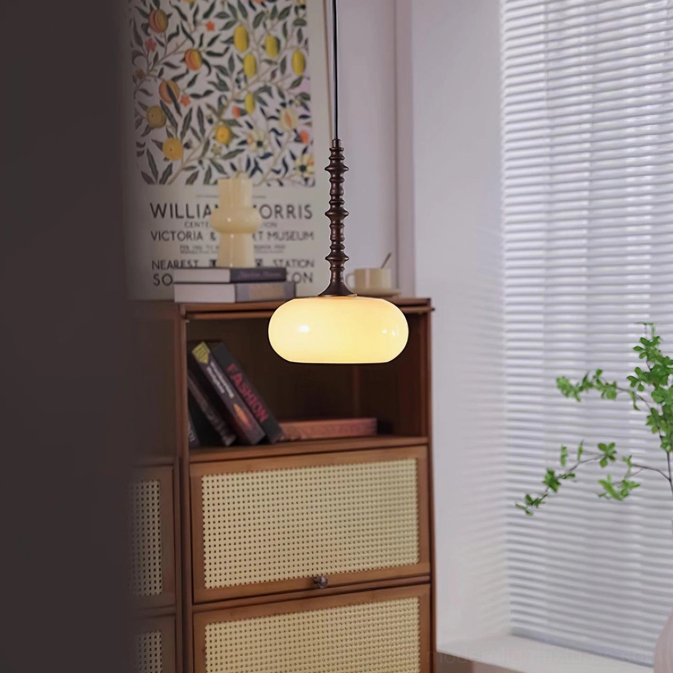 Sculptural pendant light with organic metal form and soft diffusing glass shade in modern home