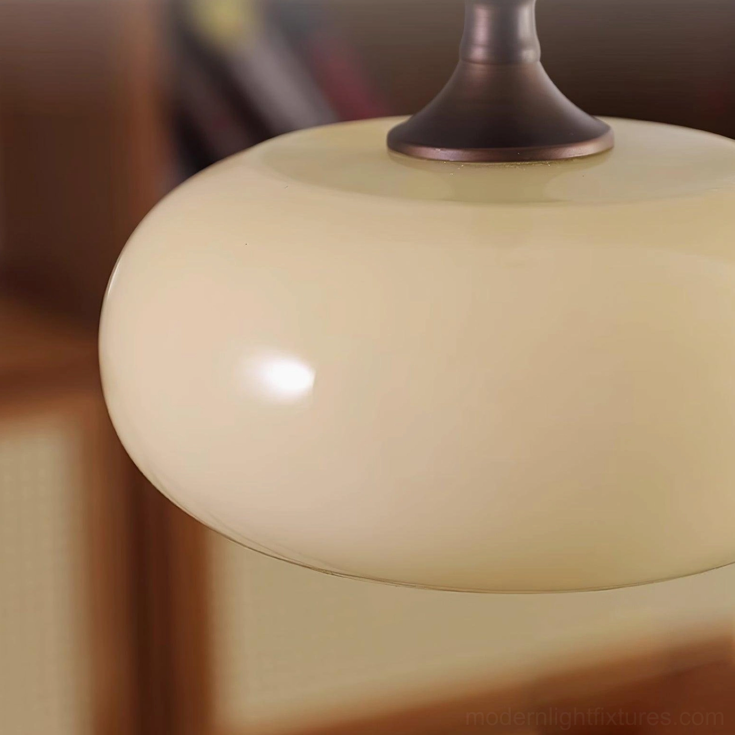 Pendant light fixture with warm amber glow through frosted white glass and dark brown frame
