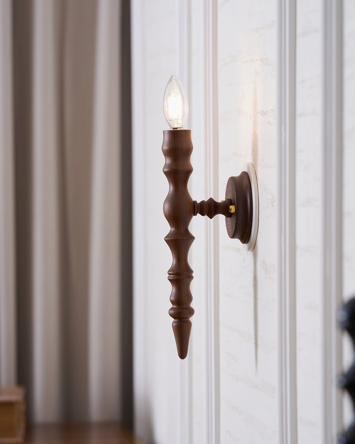 Eloise wall sconce warm candlelight illumination in residential interior setting