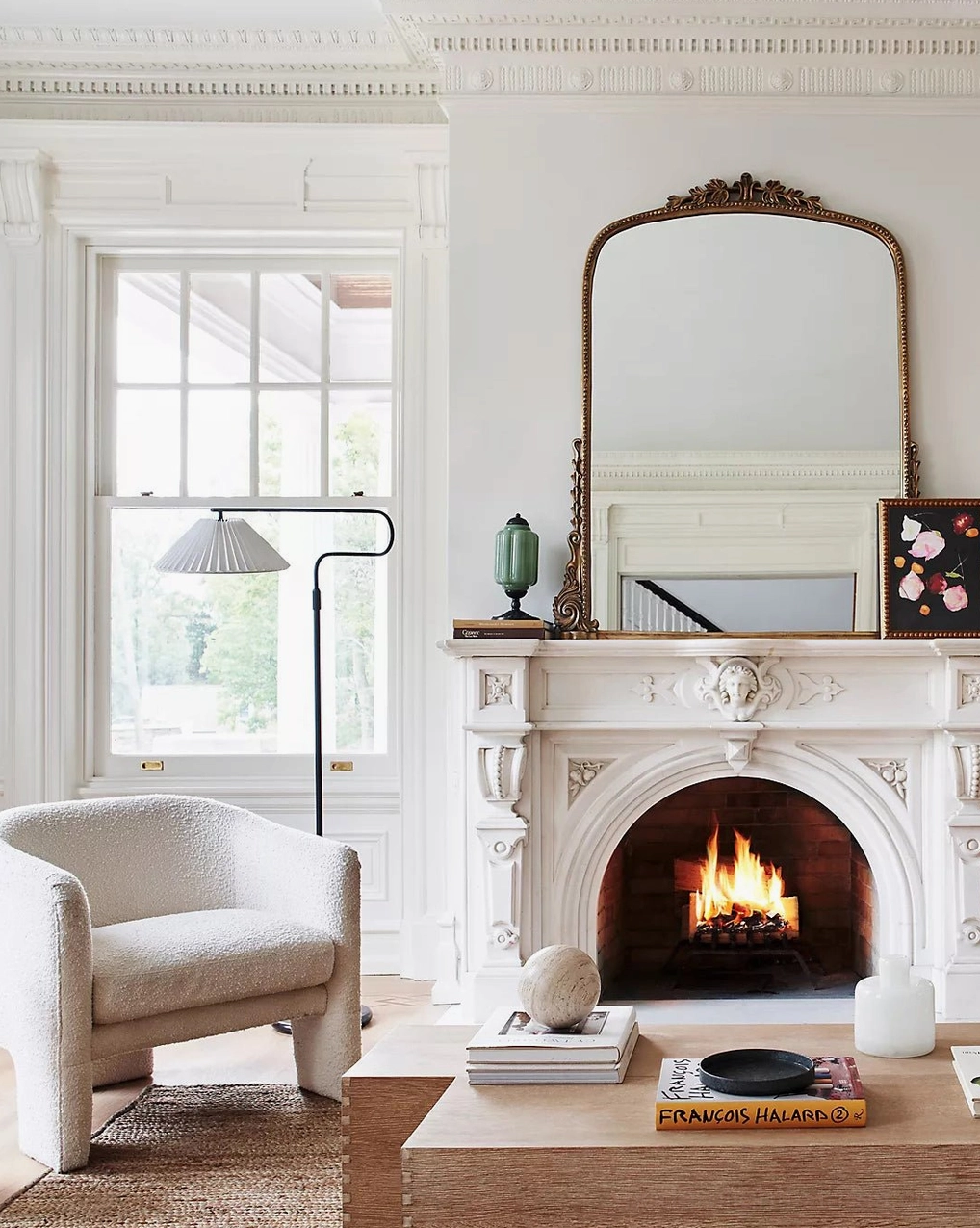 Neoclassical vintage living room with fireplace featuring matching green Eloise fluted glass table lamp in background