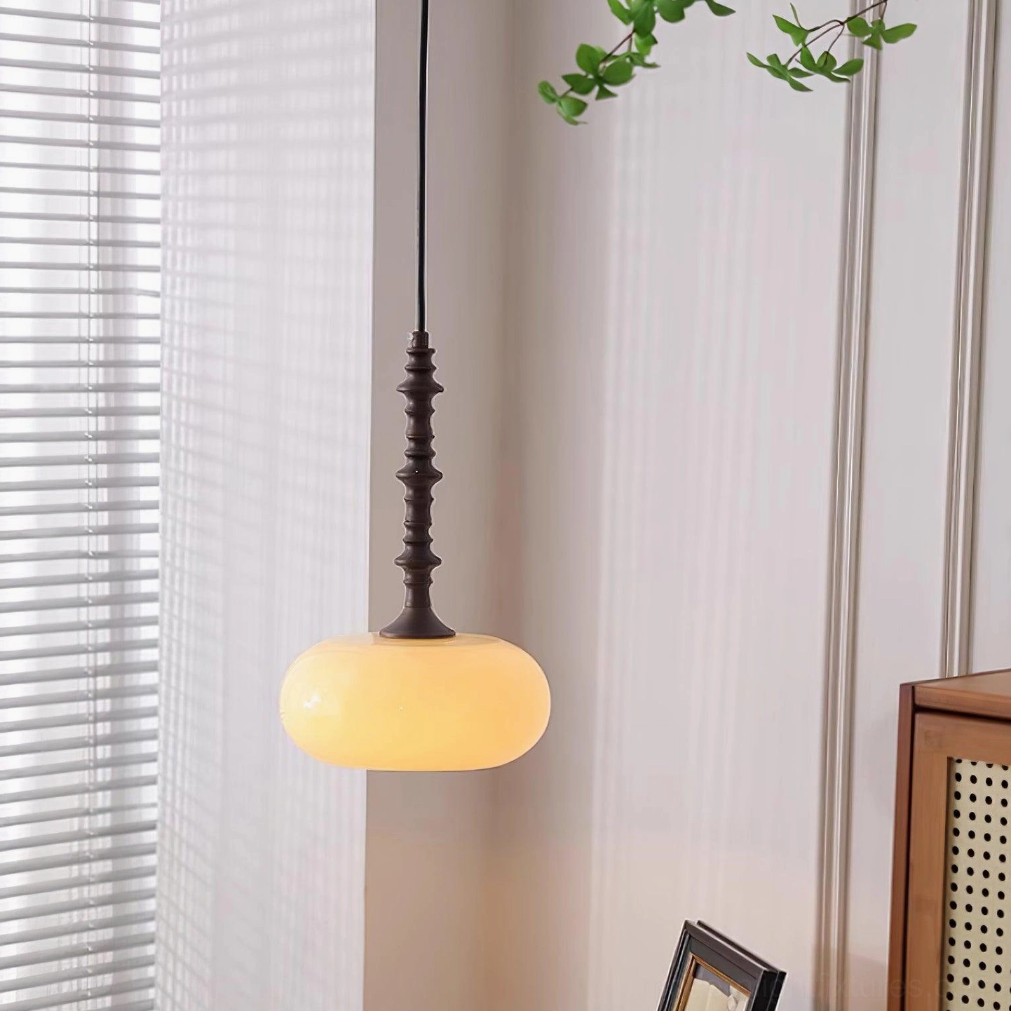 Eloise vintage pendant light with flat-round frosted glass shade and twisted dark brown metal frame in interior