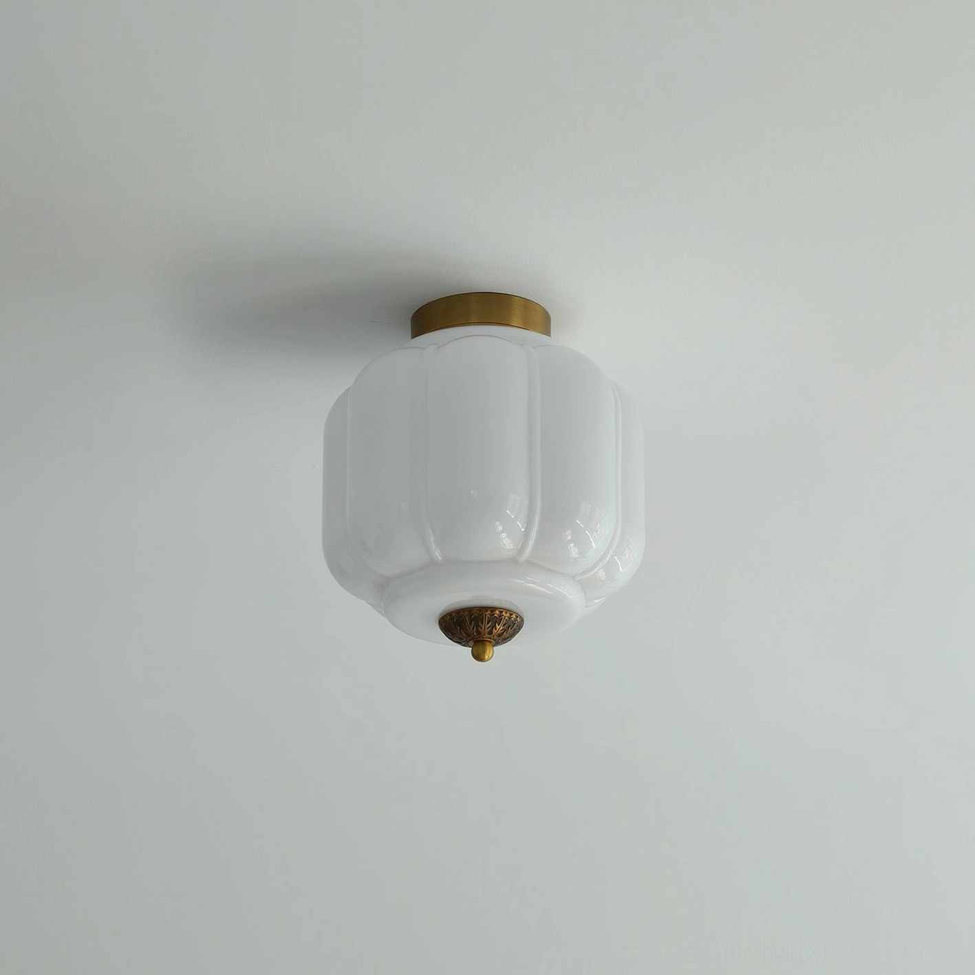 White opaline glass flush mount ceiling light with gold brass hardware