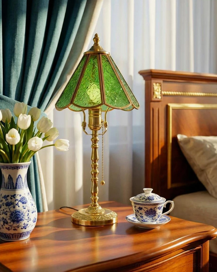 Elowen glass table lamp beside blue and white porcelain vase on wooden bed headboard