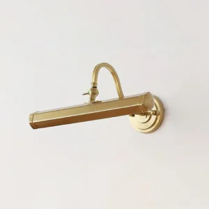 Elowen gold picture wall lamp three-quarter perspective showing adjustable swivel joint and curved arm design