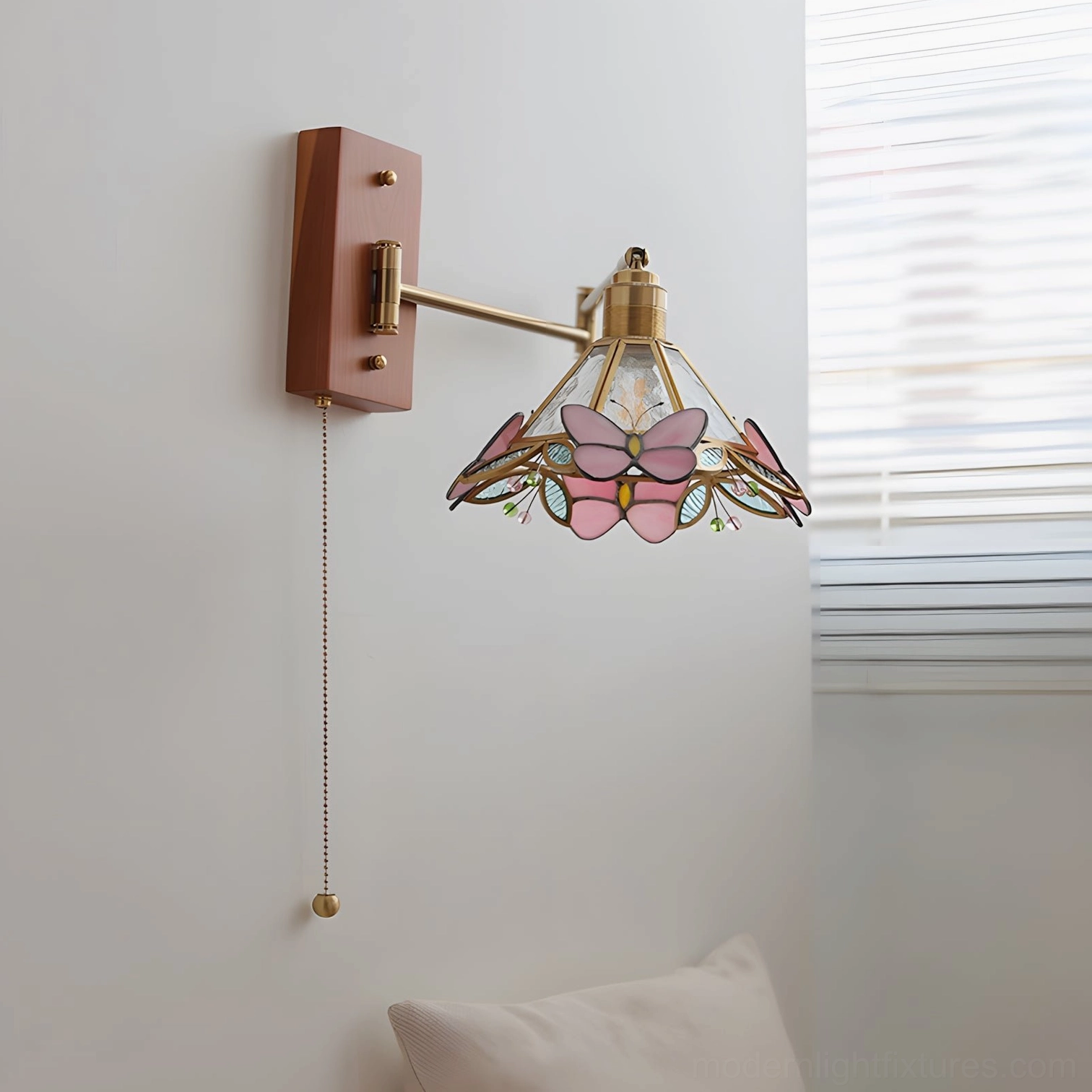 Elowen Petal Wall Sconce side view detail, pink butterfly stained shade with wood-brass frame, soft diffused light with window blind background