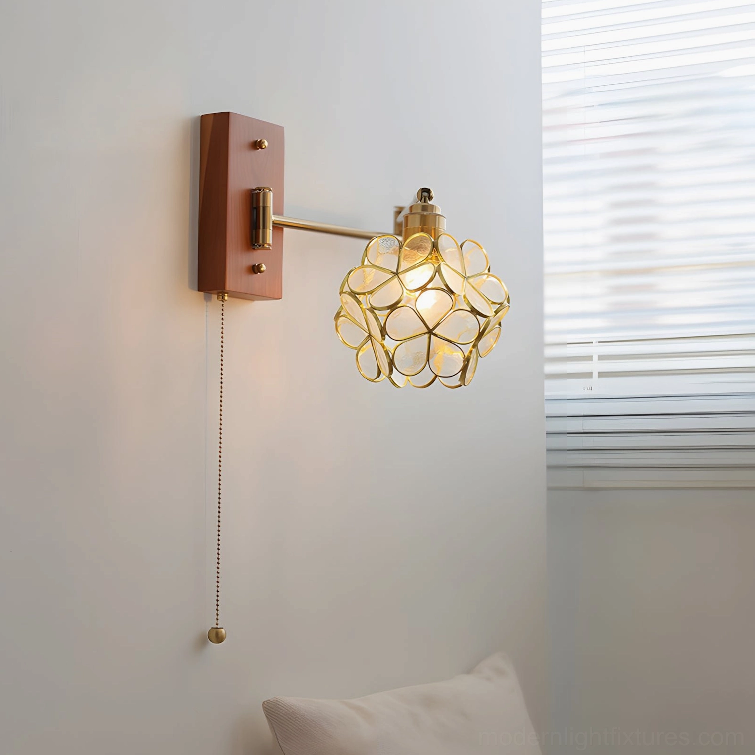 Elowen Petal Wall Sconce with hollow floral cage shade, front studio view, brass flower design with wood backplate and modern retro aesthetic