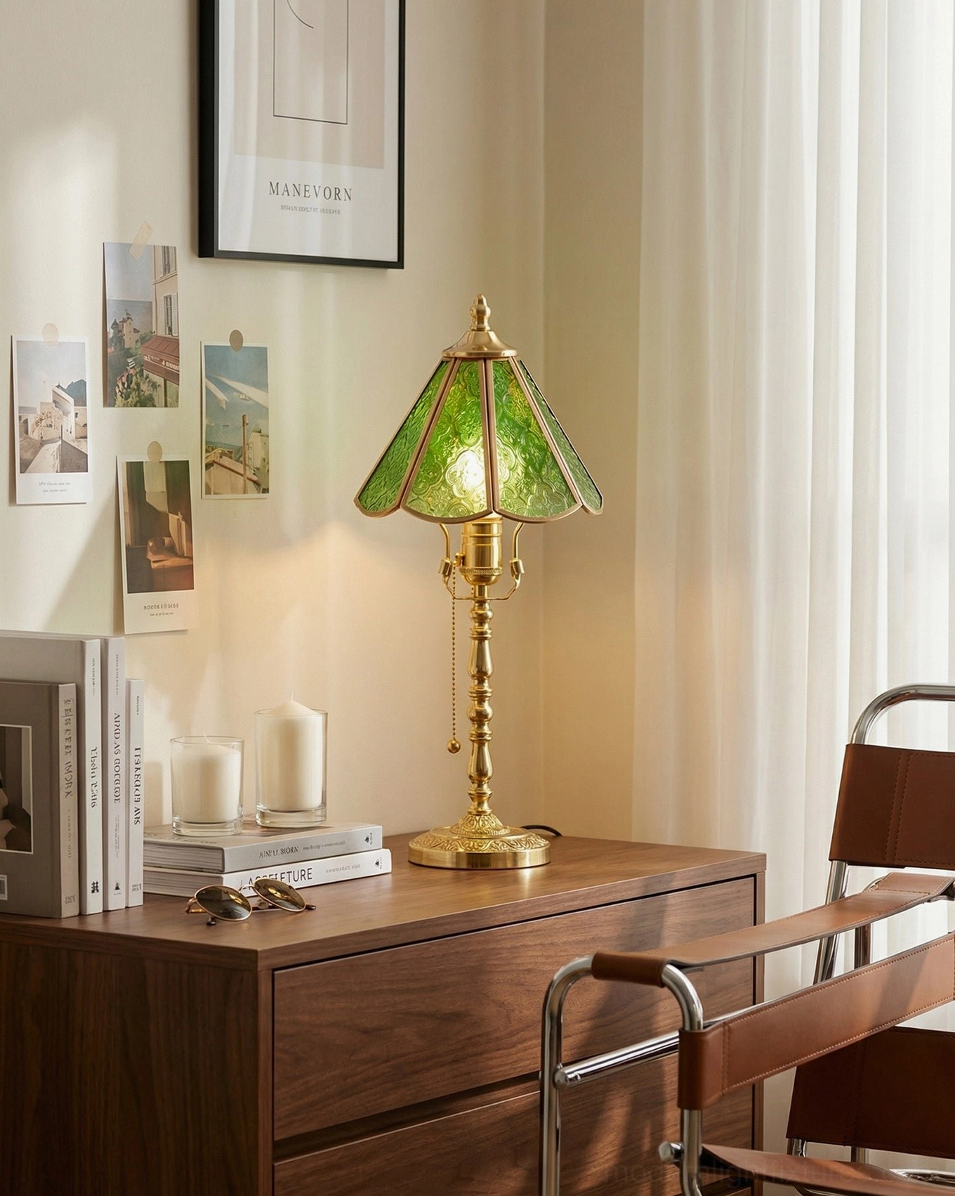 Elowen brass and green glass lamp on bedroom dresser with gallery wall and leather accent chair
