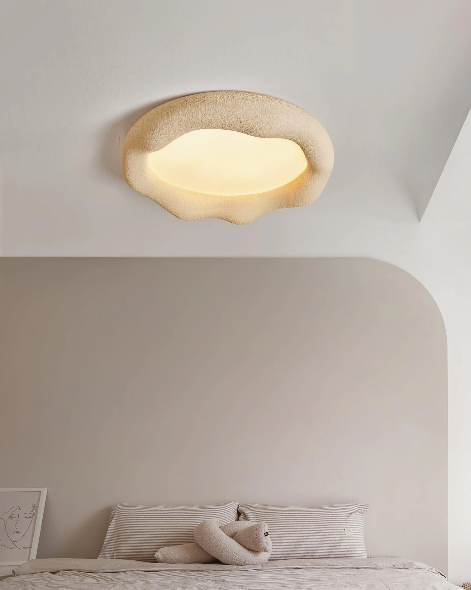 Cream irregular cloud ceiling lamp overhead view in neutral bedroom with soft rounded shape