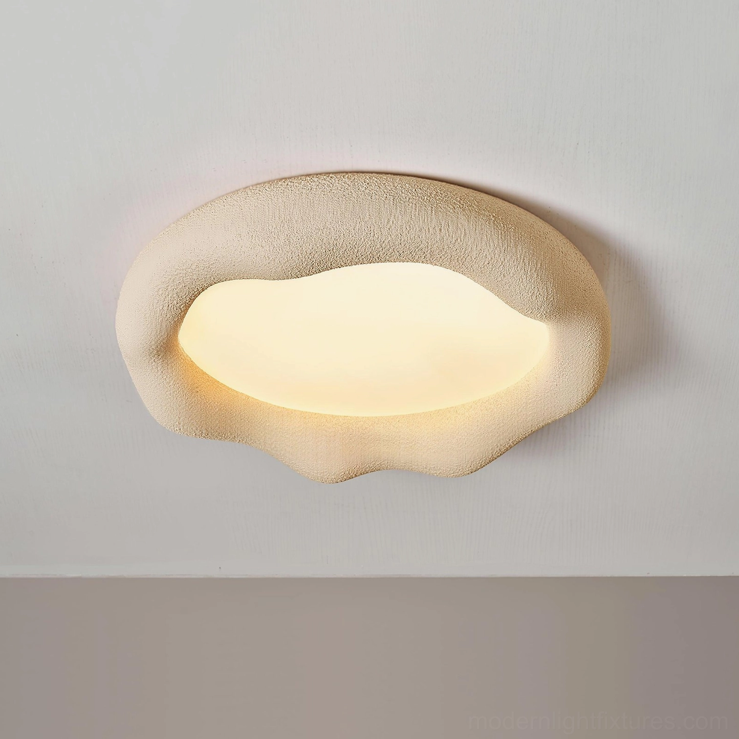 Cream textured irregular cloud light fixture close-up with matte finish and luminous lip edge