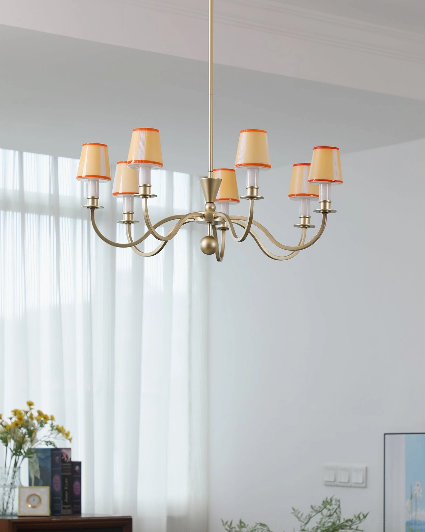 Elviera multi-light brass chandelier with orange-trimmed beige fabric shades in elegant living room setting
