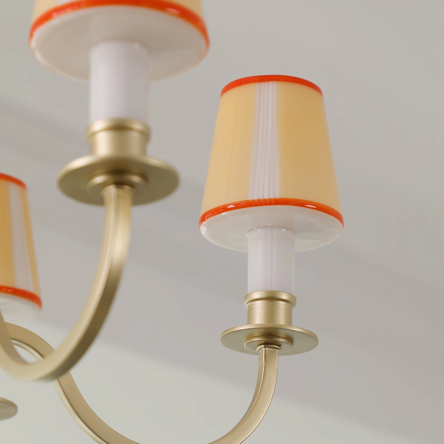 Elviera multi-head golden chandelier with diffused warm light in residential dining area