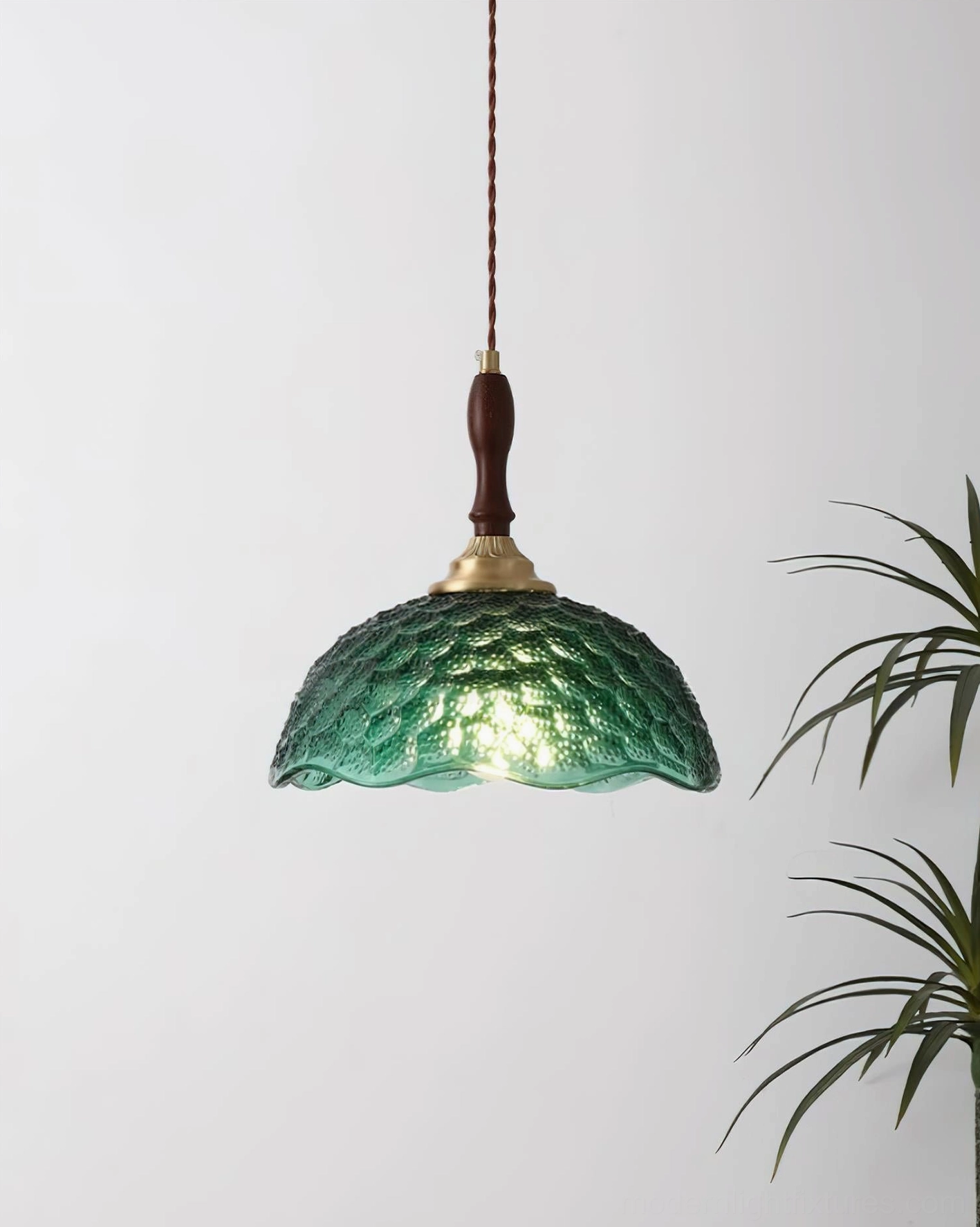 Emerald green glass pendant light low-angle view with twisted cloth cord, compact retro design