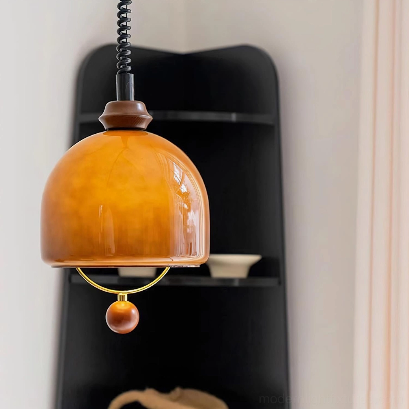 Enda modern glass dome pendant light with amber orange finish and sculptural wooden ball accent