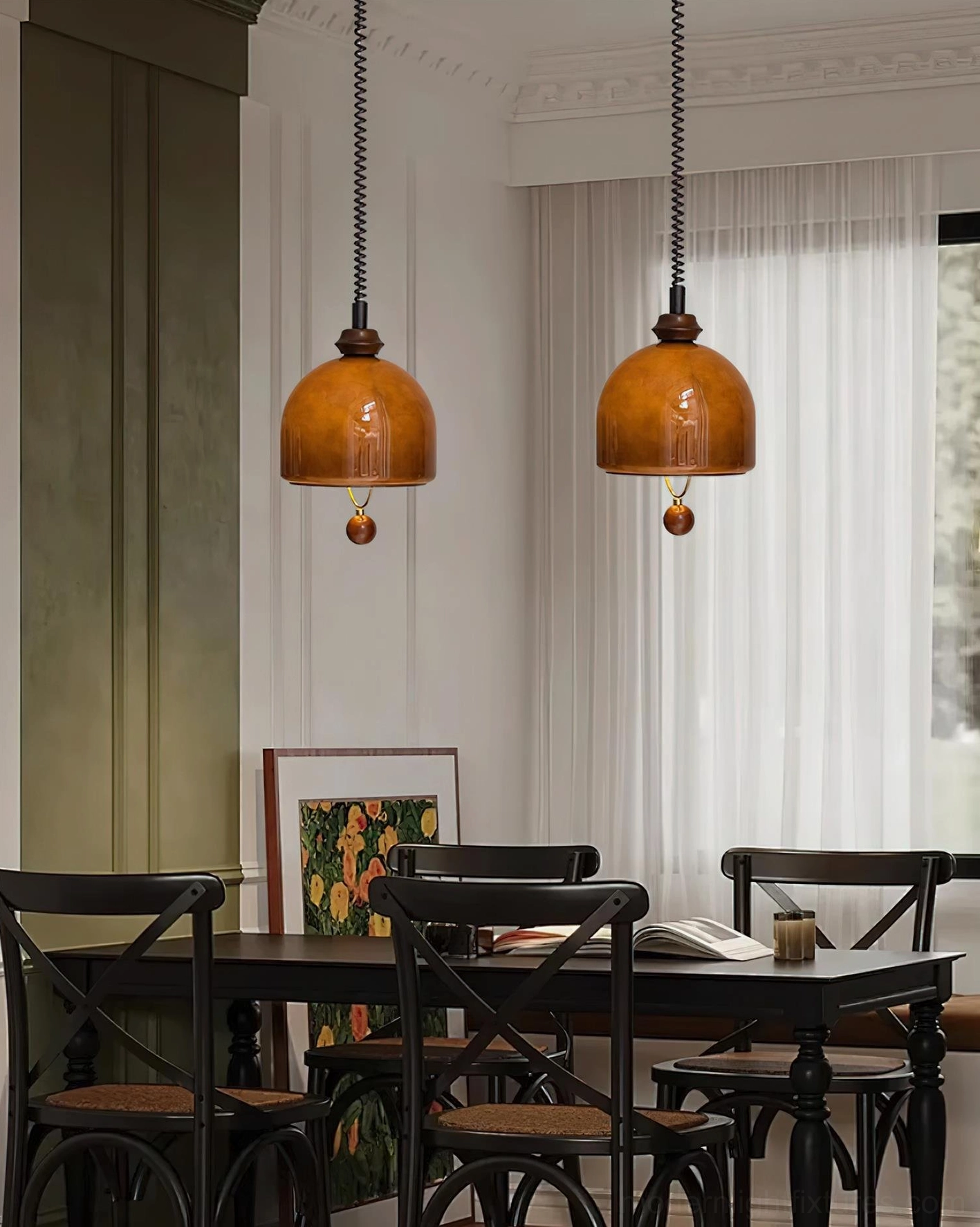 Two Enda mid-century modern glass pendant lights in French retro dining room with dark wood furniture