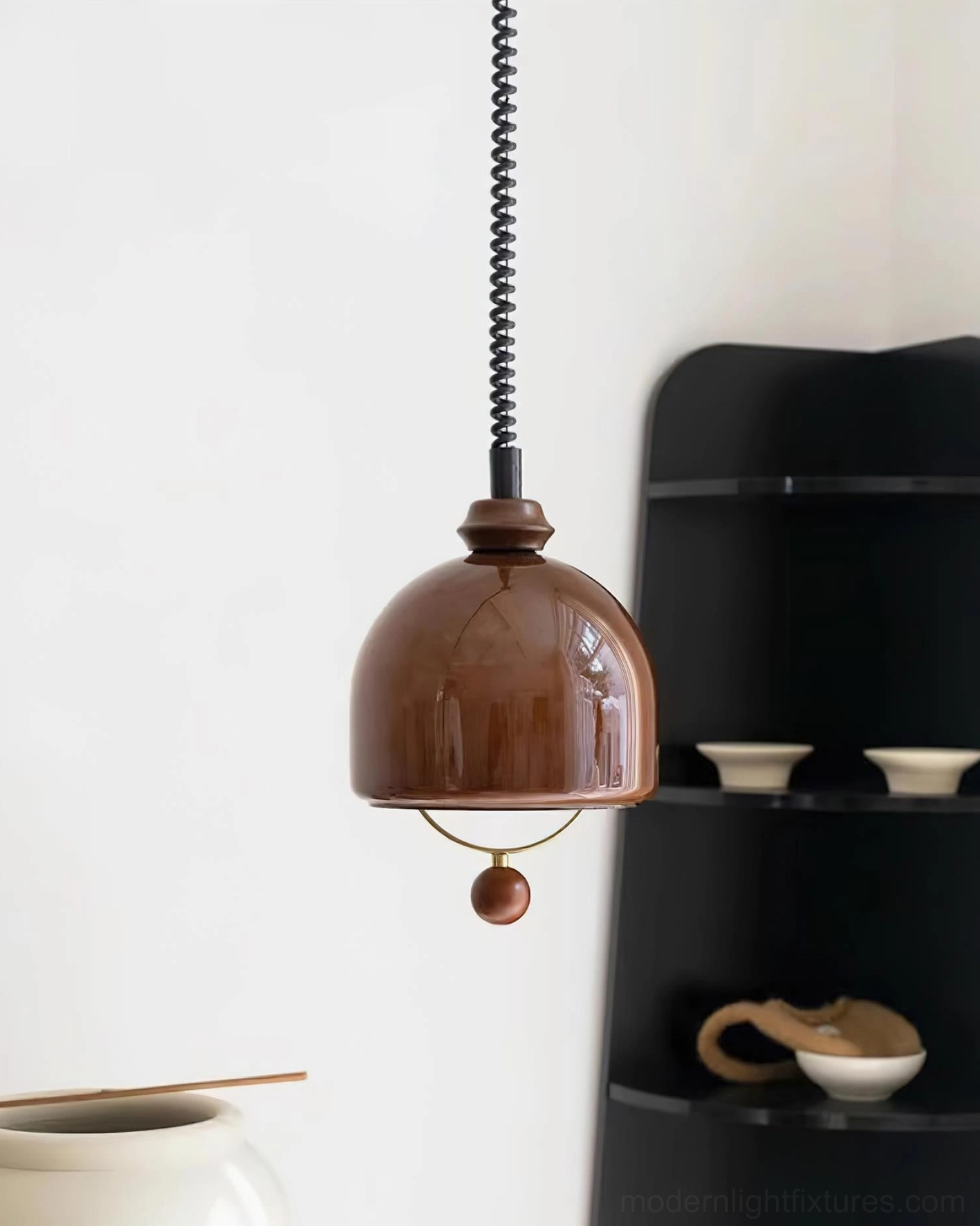 Enda mid-century modern pendant lamp three-quarter view showing glossy dome shade and wooden decorative ball