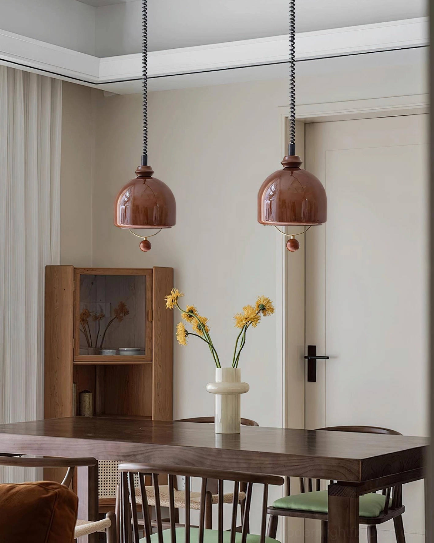 Pair of Enda vintage glass dome pendant lights in glossy brown shade suspended above wooden dining table
