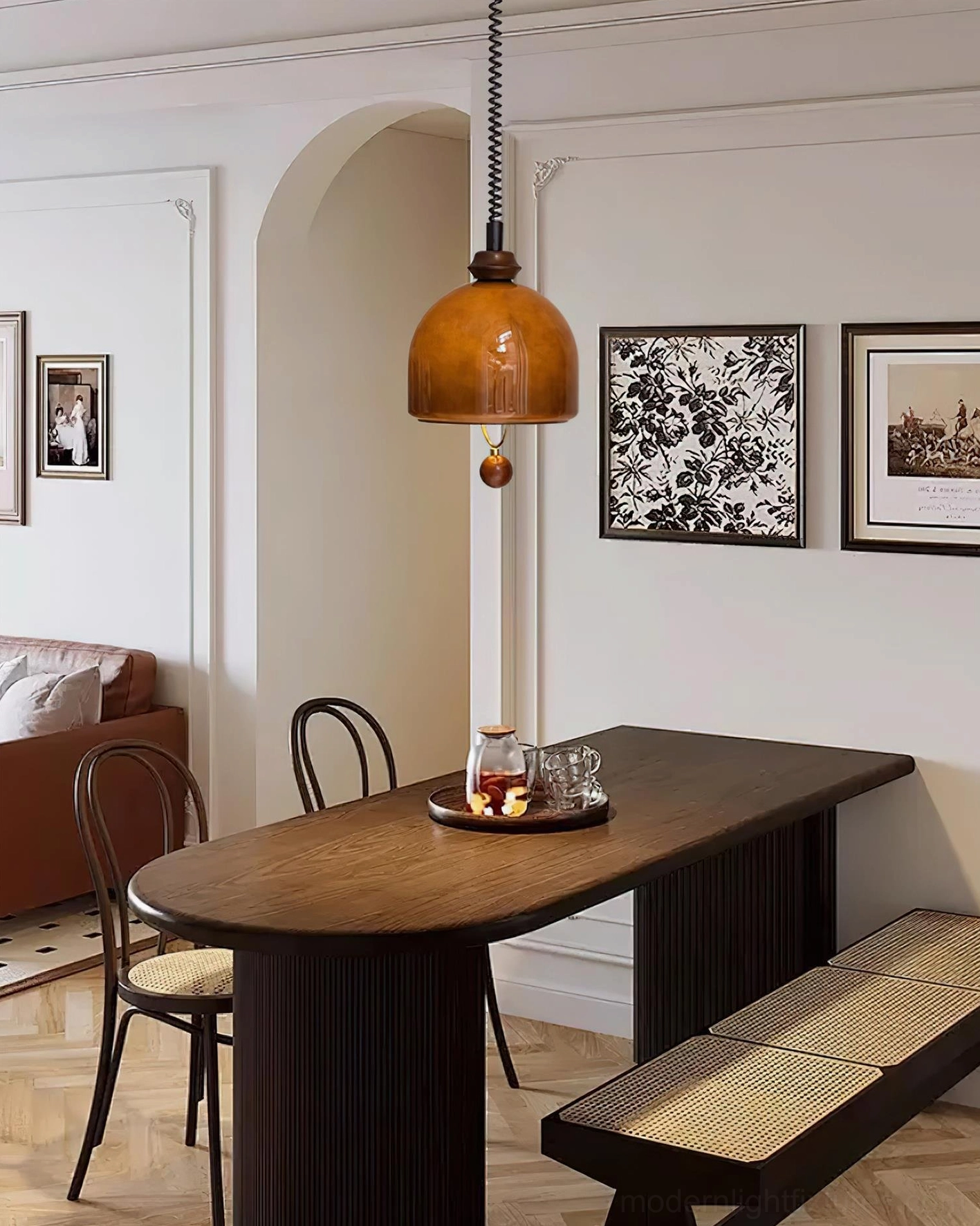 Enda retro glass pendant light with glossy amber dome shade paired with vintage wall art in dining room