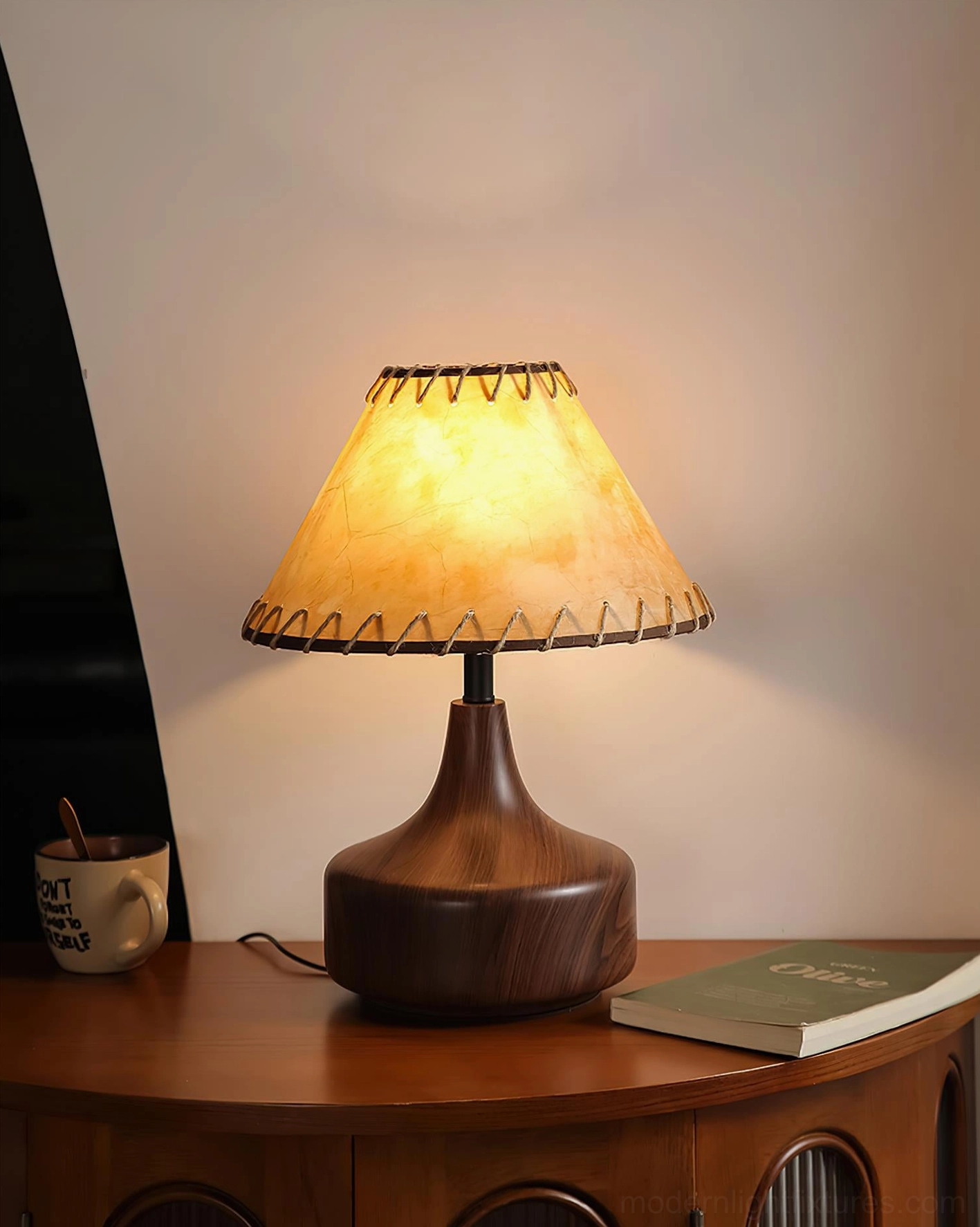 Enora table lamp with glowing parchment shade and walnut-color wooden base