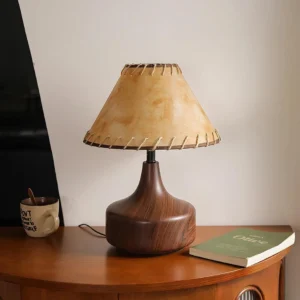 Enora wood-grain base table lamp with warm ambient lighting on bedside table