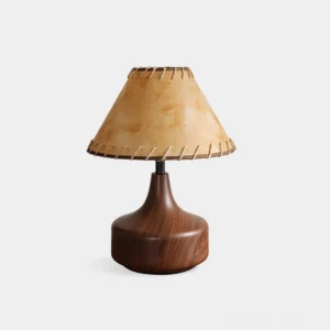 Enora walnut wood table lamp with hand-stitched tan parchment shade, studio front view