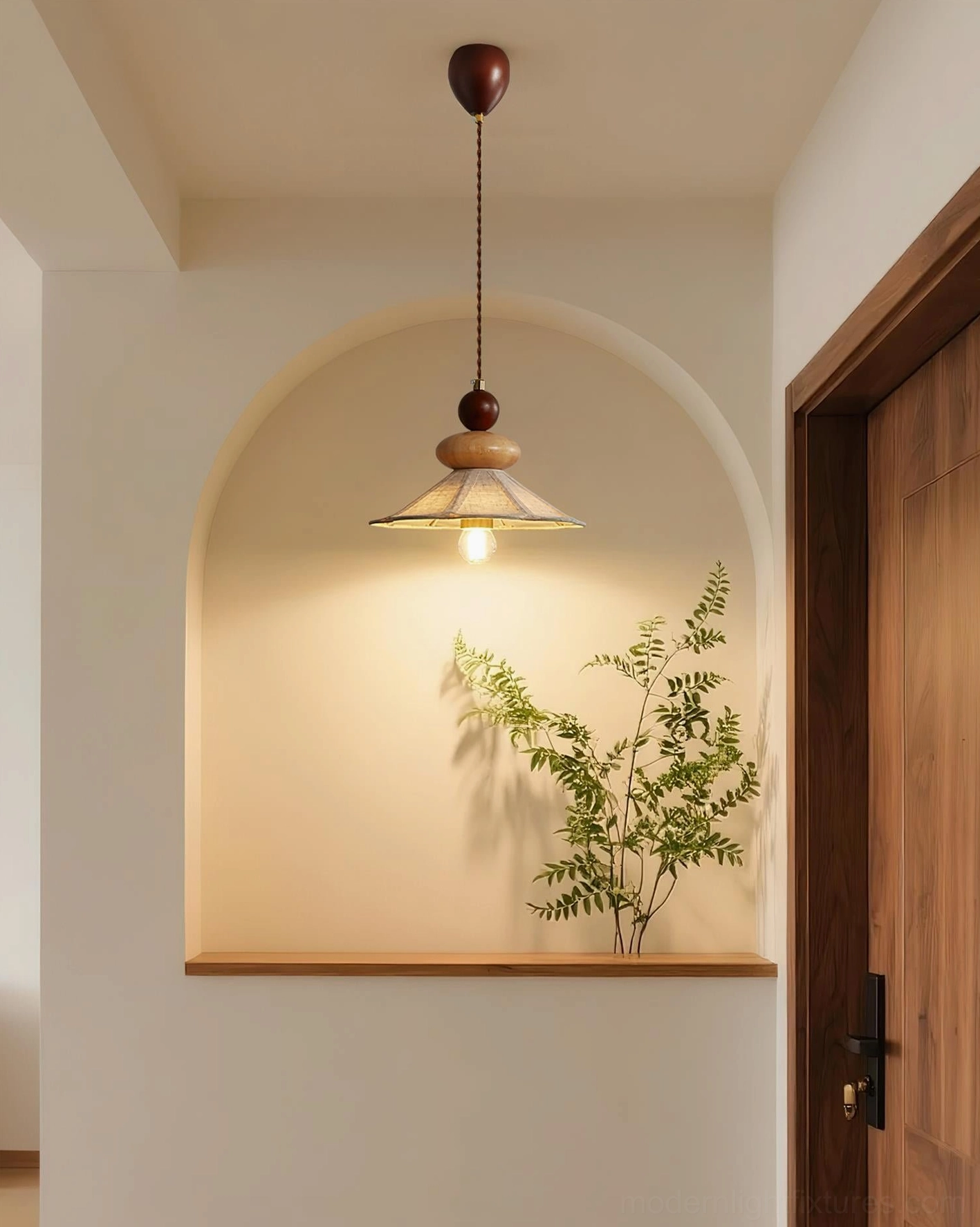 Single wooden pendant lamp in hallway nook with arched wall and green plant, minimalist warm accent lighting design