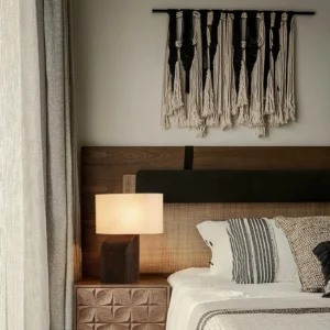 Esla minimalist table lamp on wooden nightstand in bedroom, warm ambient lighting in interior bedroom setting