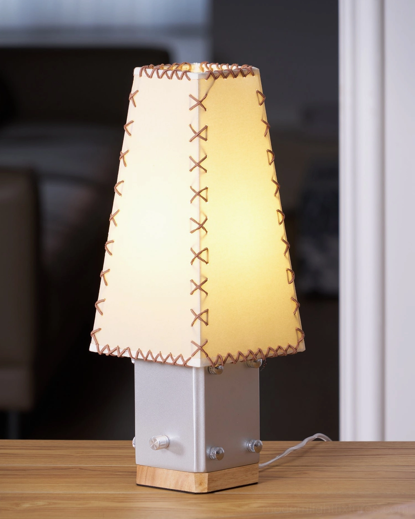 Estela handcrafted table lamp showcasing stitched fabric shade and geometric base design detail