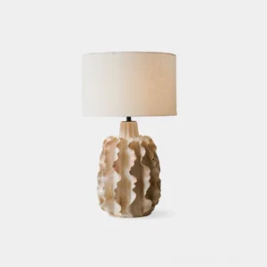Eterne sculptural ceramic table lamp with ruffled base and drum shade, front studio view